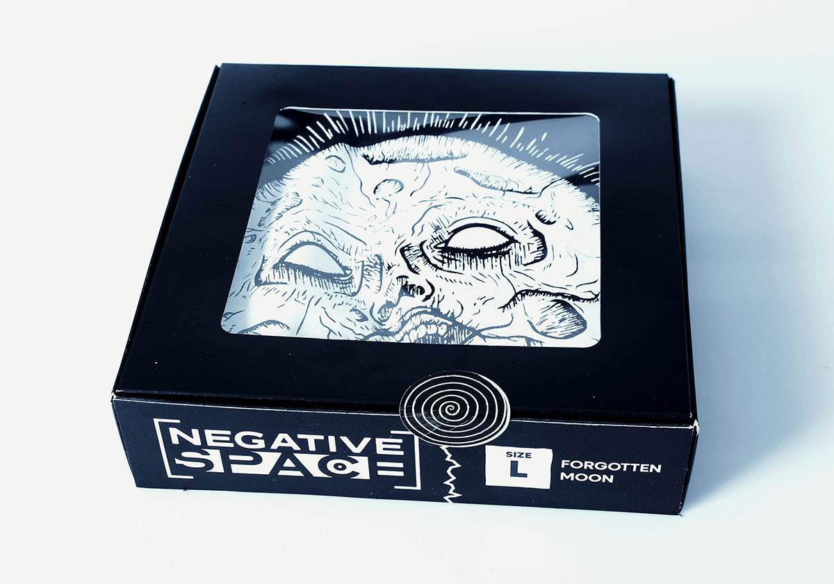 A Forgotten Moon shirt placed in a box package