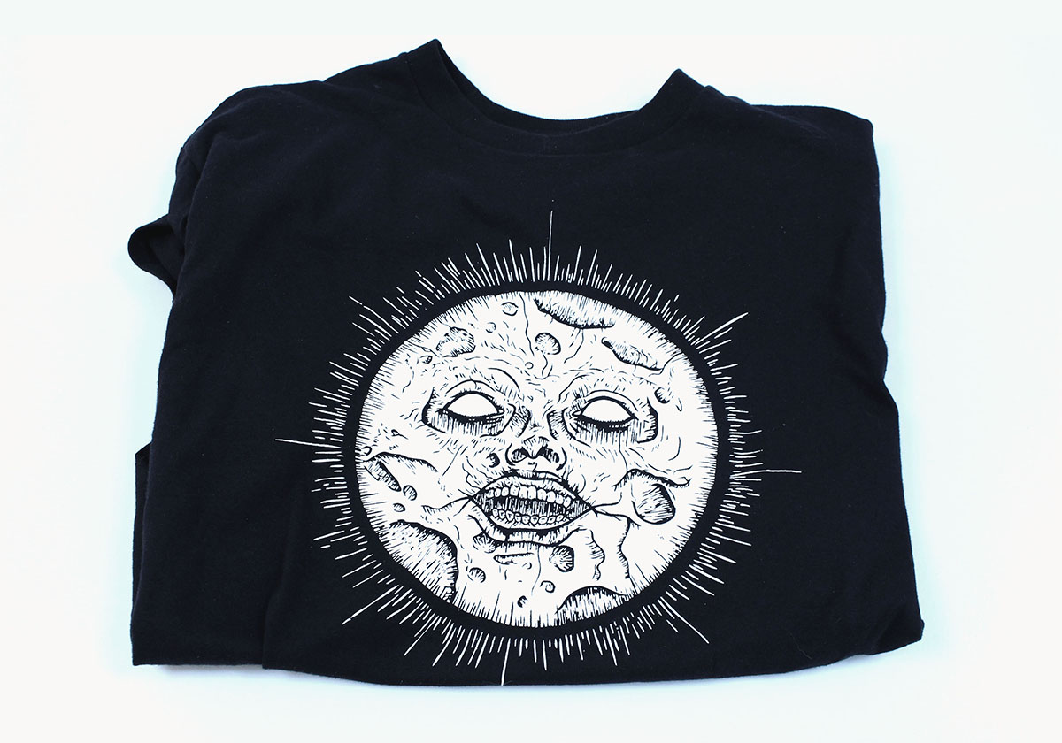 A folded Forgotten Moon shirt